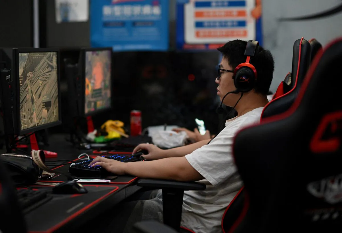 A man plays an online game at a computer shop in Beijing on Aug. 31, 2021, a day after China announced a drastic cut to children's online gaming time to just three hours a week. (Noel Celis/AFP)
