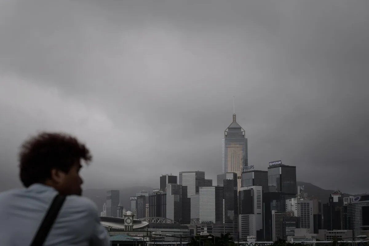 A man looks at the dark clouds over the city's skyline in Hong Kong on Aug. 14, 2013.   (Philippe Lopez/AFP via Getty Images)