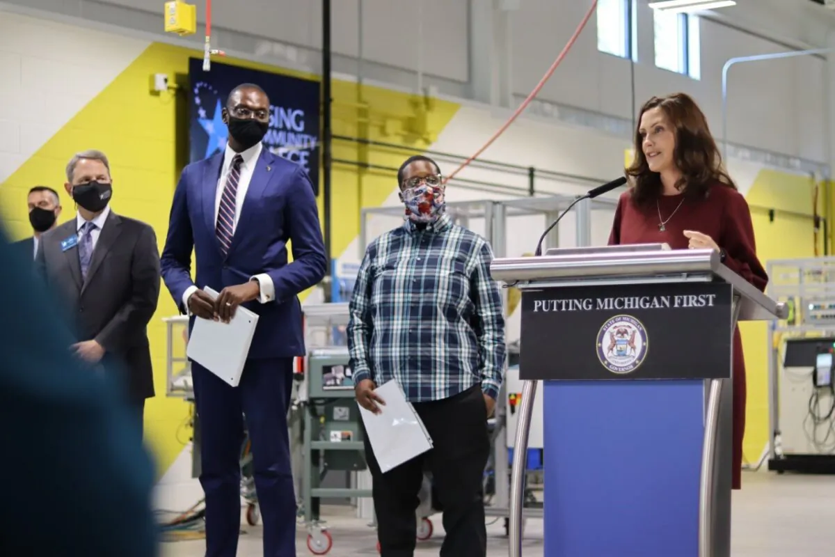 Michigan Gov. Gretchen Whitmer signs the fiscal year 2022 budget into law at Lansing Community College in Lansing, Mich., on Sept. 29, 2021. (Courtesy of Whitmer's office)