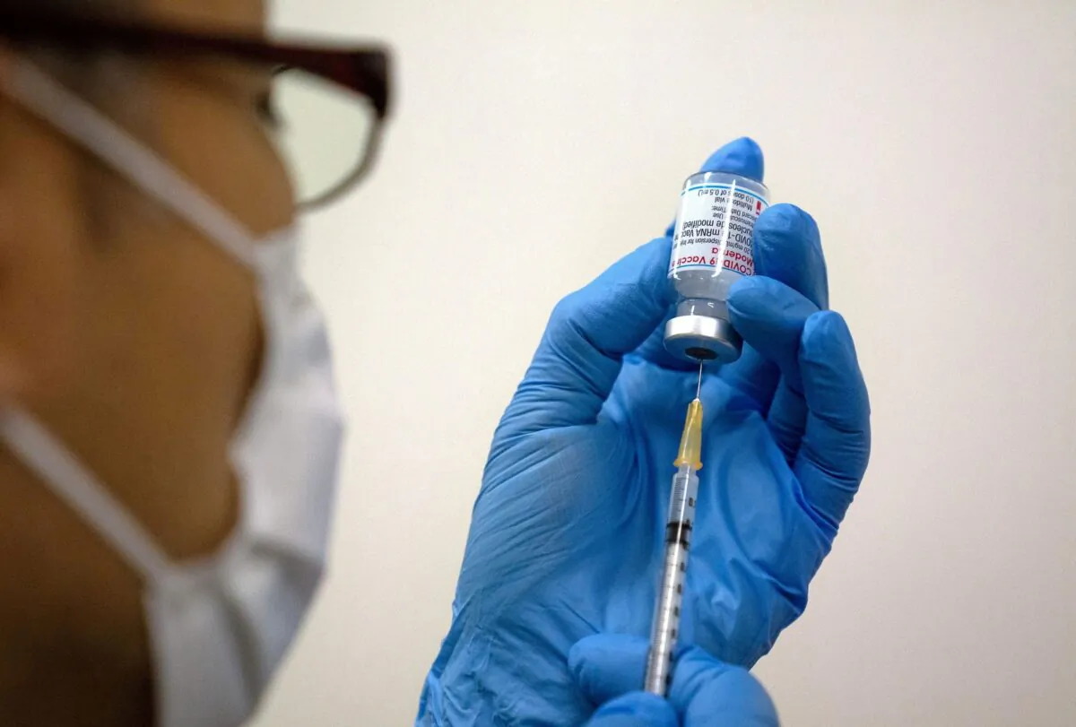 Medical staff prepare Moderna coronavirus (COVID-19) vaccine to be administered at mass vaccination center in Tokyo on May 24, 2021. (Carl Court/Pool via Reuters)