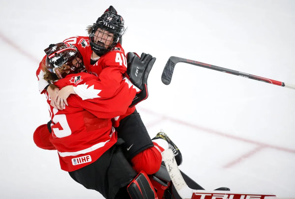 Canada goalie Ann-Renee Desbiens (L) and teammate Blayre Turnbull celebrate the team's overtime win against the United States in the IIHF hockey women's world championships title game in Calgary, Alberta, Canada, on Aug. 31, 2021. (Jeff McIntosh/The Canadian Press via AP)
