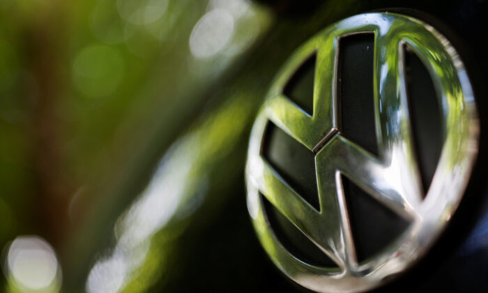 A logo of German carmaker Volkswagen is seen on a car parked on a street in Paris, France on July 9, 2020. (Christian Hartmann/Reuters)