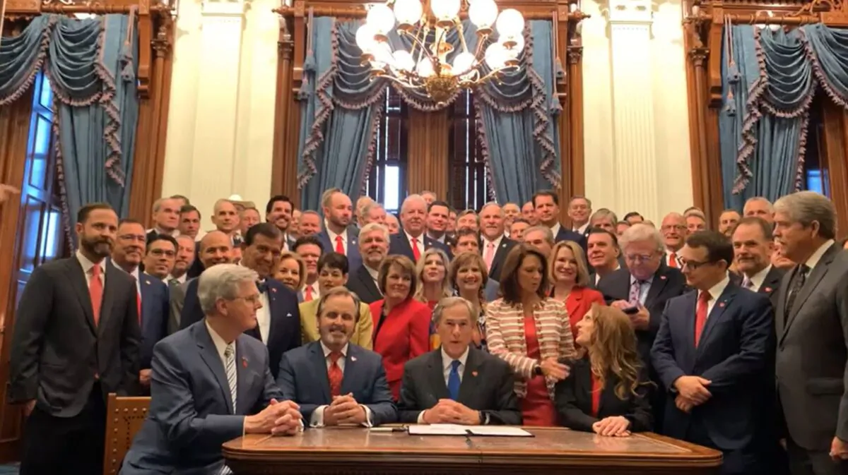 Texas Gov. Greg Abbott (C) and state lawmakers at a signing ceremony for Senate Bill 8 in Austin, Texas, on May 19, 2021. (Office of Gov. Greg Abbott/Screenshot via The Epoch Times)