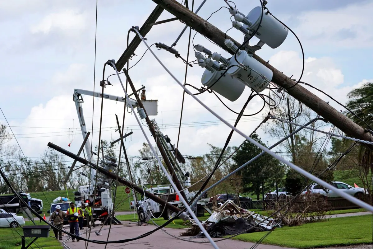 Crews begin work on downed power lines leading to a fire station, in Waggaman, La., on Aug. 31, 2021. (Steve Helber/AP Photo)