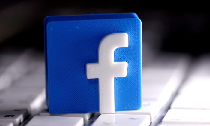 A 3D-printed Facebook logo is seen placed on a keyboard in this illustration taken March 25, 2020. (Dado Ruvic/Illustration/Reuters,File Photo)
