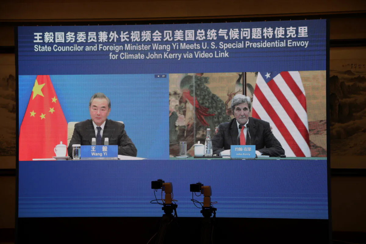 U.S. Special Presidential Envoy for Climate John Kerry is seen on a screen with Chinese State Councilor and Foreign Minister Wang Yi during a meeting via video link on Sept. 1, 2021. (U.S. Department of State/Handout via Reuters)