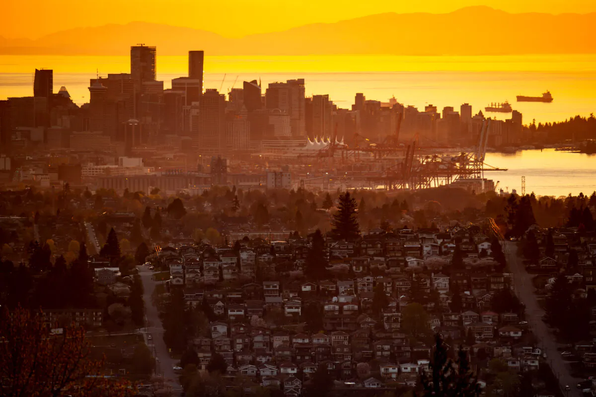 The downtown Vancouver skyline is seen at sunset, as houses line a hillside in Burnaby, B.C., on April 17, 2021. (The Canadian Press/Darryl Dyck)