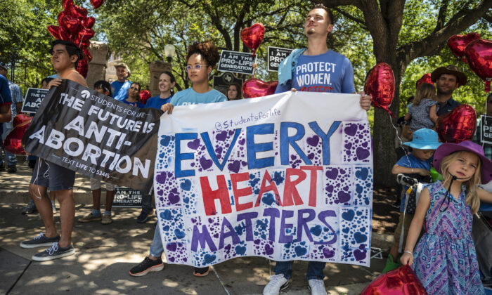 Pro-life protesters stand near the gate of the Texas state capitol on May 29, 2021. (Sergio Flores/Getty Images)