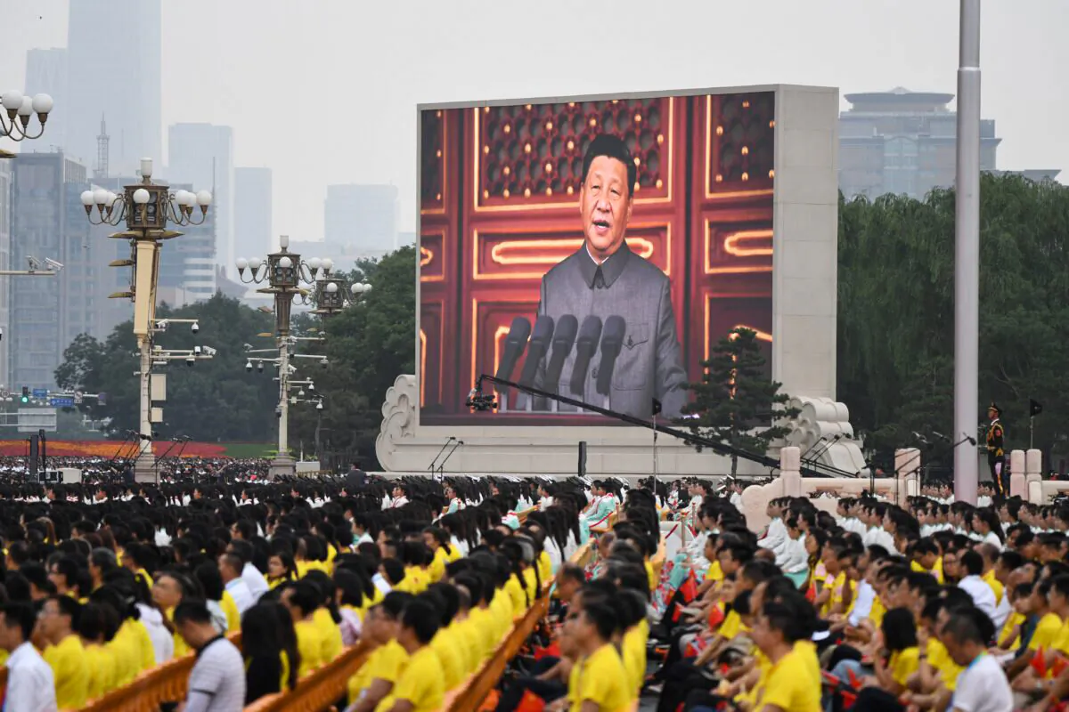 Chinese leader Xi Jinping (on screen) delivers a speech during the celebrations of the 100th anniversary of the founding of the Communist Party of China, at Tiananmen Square in Beijing, on July 1, 2021. (Wang Zhao/AFP via Getty Images)