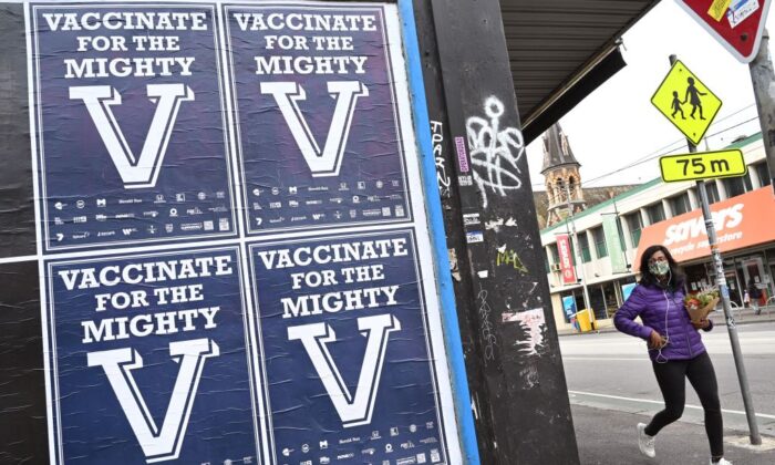 A person walks past posters encouraging people to get vaccinated in Melbourne, Australia on Aug. 31, 2021. (William West/AFP via Getty Images)