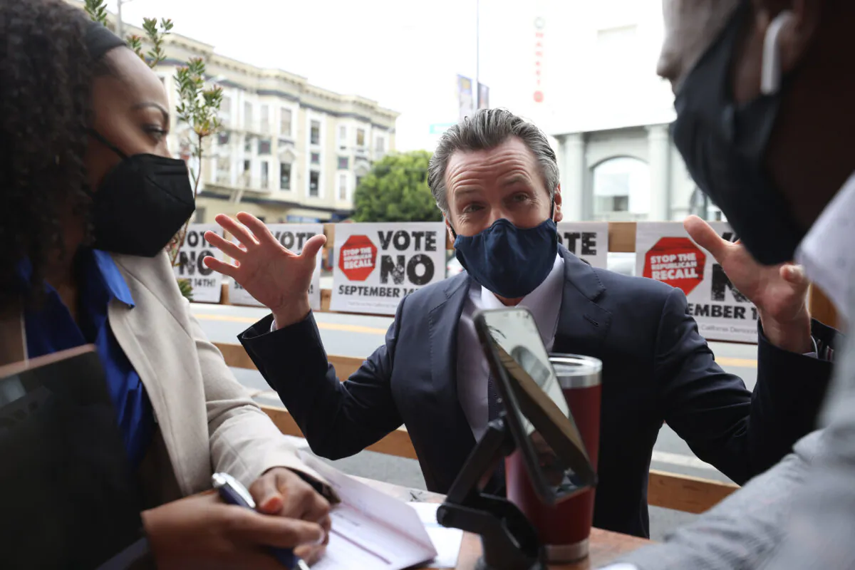 California Gov. Gavin Newsom talks with supporters as he campaigns against the recall election held on Sept. 14, 2021. (Justin Sullivan/Getty Images)