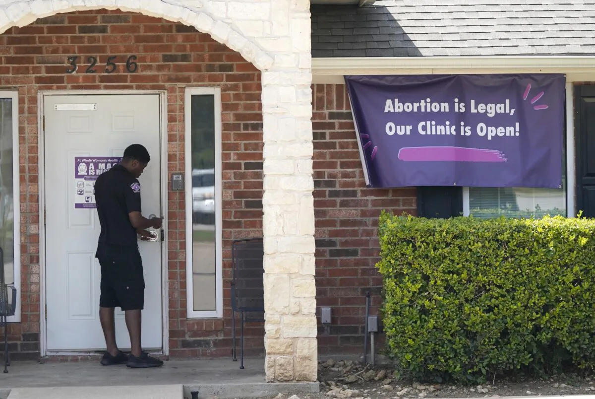 A security guard opens the door to the Whole Women's Health Clinic in Fort Worth, Texas on Sept. 1, 2021. (LM Otero/AP Photo)