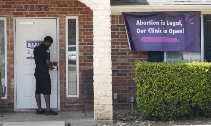 A security guard opens the door to the Whole Women's Health Clinic in Fort Worth, Texas, on Sept. 1, 2021. (LM Otero/AP Photo)