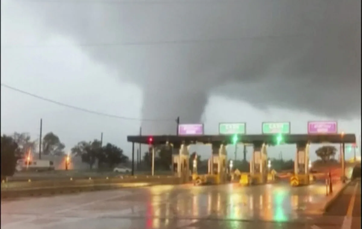 In this image taken from video provided by Scott Smith, a fast-moving tornado is seen in the distance through a windshield just before the toll booth for the Burlington Bristol Bridge in Burlington, N.J., on Sept. 1, 2021. (Scott Smith via AP)