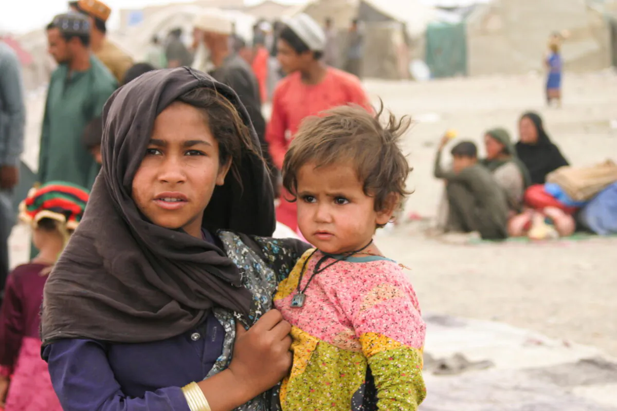 Siblings who arrived from Afghanistan with their families are seen at their makeshift tents as they take refuge near a railway station in Chaman, Pakistan, on Sept. 1, 2021. (Saeed Ali Achakzai/Reuters)