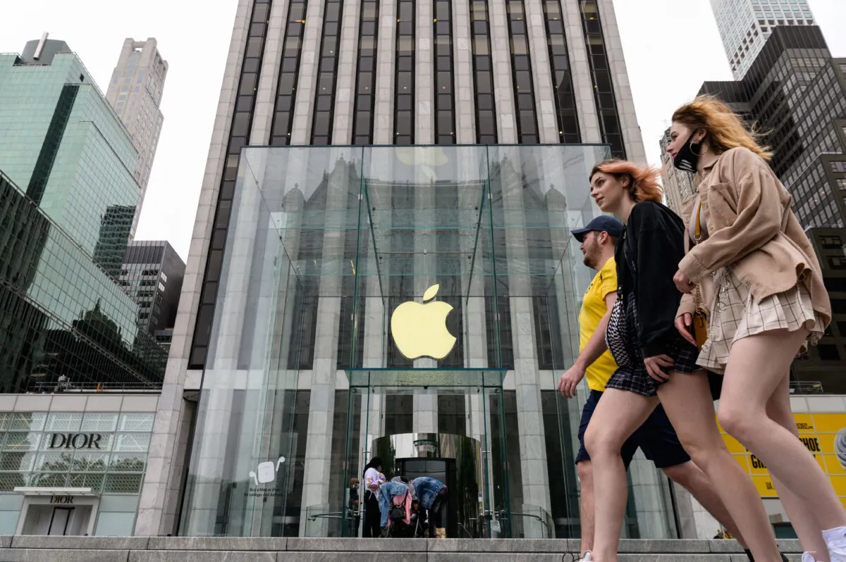 People walk past an Apple retail store on July 13, 2021 in New York City. (Angela Weiss/AFP via Getty Images)