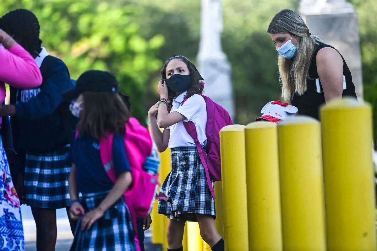 A student wears a facemask as she enters the St. Lawrence Catholic School on the first day of school after summer vacation in north of Miami, on Aug.18, 2021. (Chandan Khanna/AFP via Getty Images)