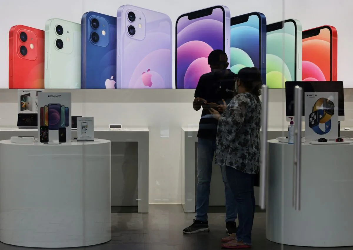 A salesperson speaks to a customer at an Apple reseller store in Mumbai, India, on Sept. 1, 2021. (Francis Mascarenhas/Reuters)