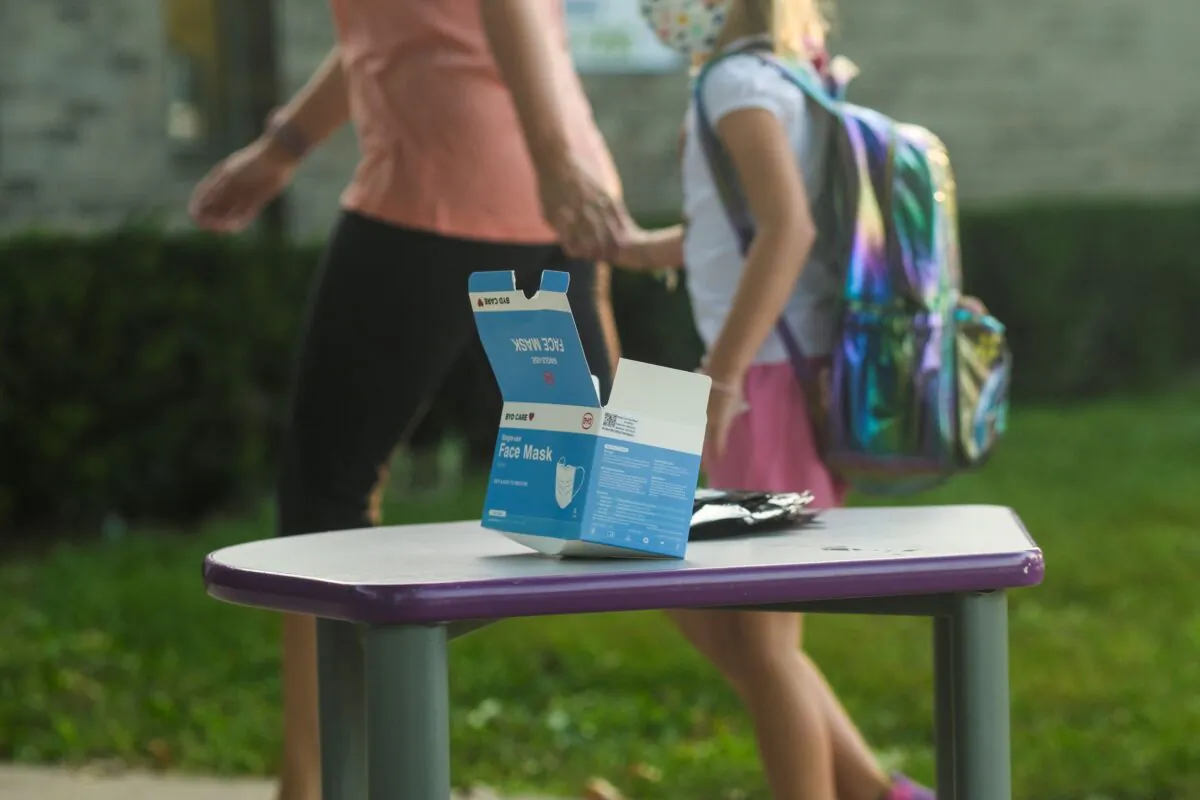 Face masks sit on a table outside of Schoolcraft Elementary for students and parents to wear when entering the building on the first day of school in Schoolcraft, Mich., on Aug. 30, 2021. (Matthew Hatcher/Getty Images)