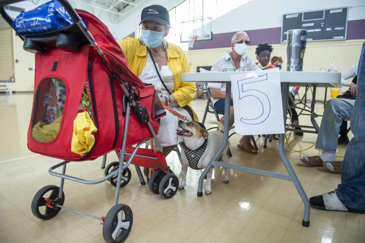Viana Chacol, 65, and her dog, Chanel, rest at a cooling shelter at the Treme Recreation Community Center in New Orleans, La., on Sept. 2, 2021. (Chris Granger/The Times-Picayune/The New Orleans Advocate via AP)