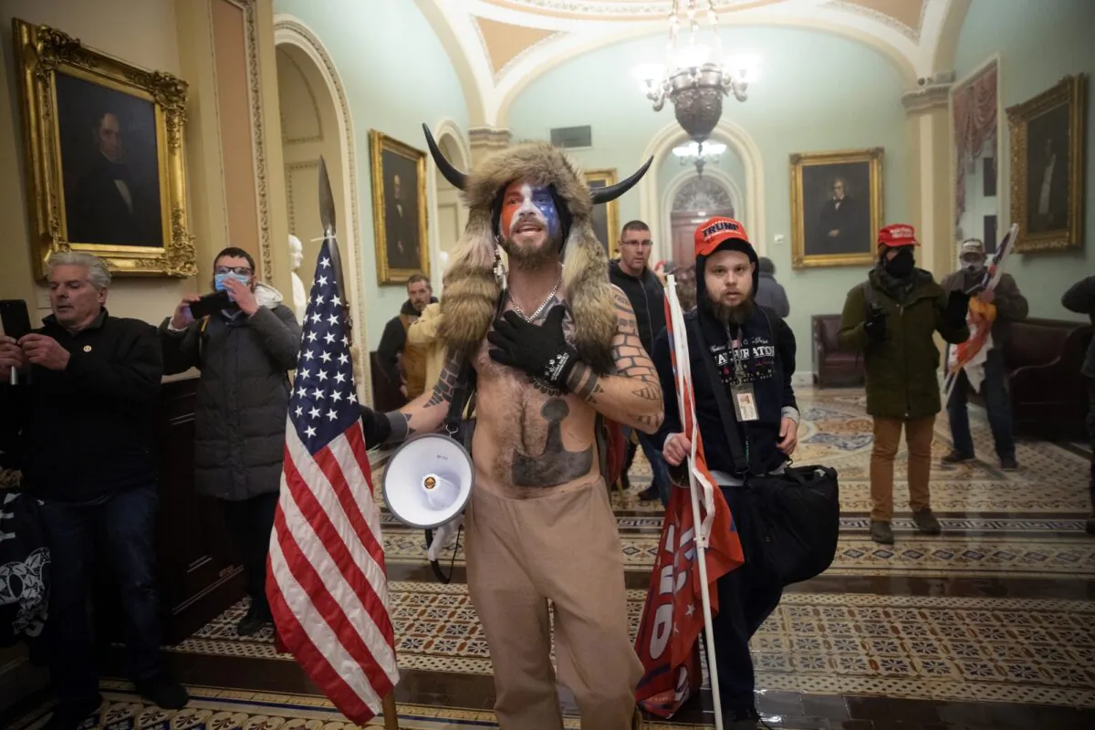 Nicholas Rodean, wearing a red hat, and Jacob Chansley inside the U.S. Capitol in Washington on Jan. 6, 2021. (Win McNamee/Getty Images)