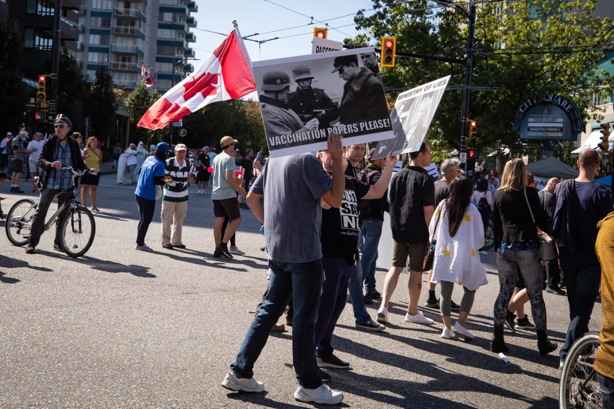People march during a protest against COVID-19 vaccine passports and mandatory vaccinations for health-care workers, in Vancouver on Sept. 1, 2021. The protest began outside Vancouver General Hospital and police estimated the crowd gathered to be as many as 5,000 people. (The Canadian Press/Darryl Dyck)