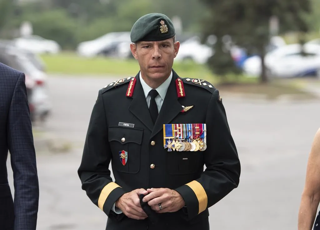 Maj.-Gen. Dany Fortin arrives to be processed at the Gatineau Police Station in Gatineau, Que., on Aug. 18, 2021. (The Canadian Press/Justin Tang)