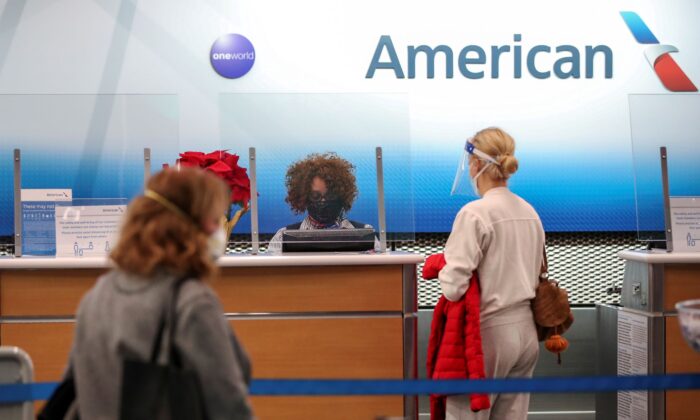 American Airlines agent helps a customer to check in for her flight at O'Hare International Airport ahead of the Thanksgiving holiday during the coronavirus disease (COVID-19) pandemic, in Chicago, Ill., on Nov. 25, 2020. (Kamil Krzaczynski/Reuters)