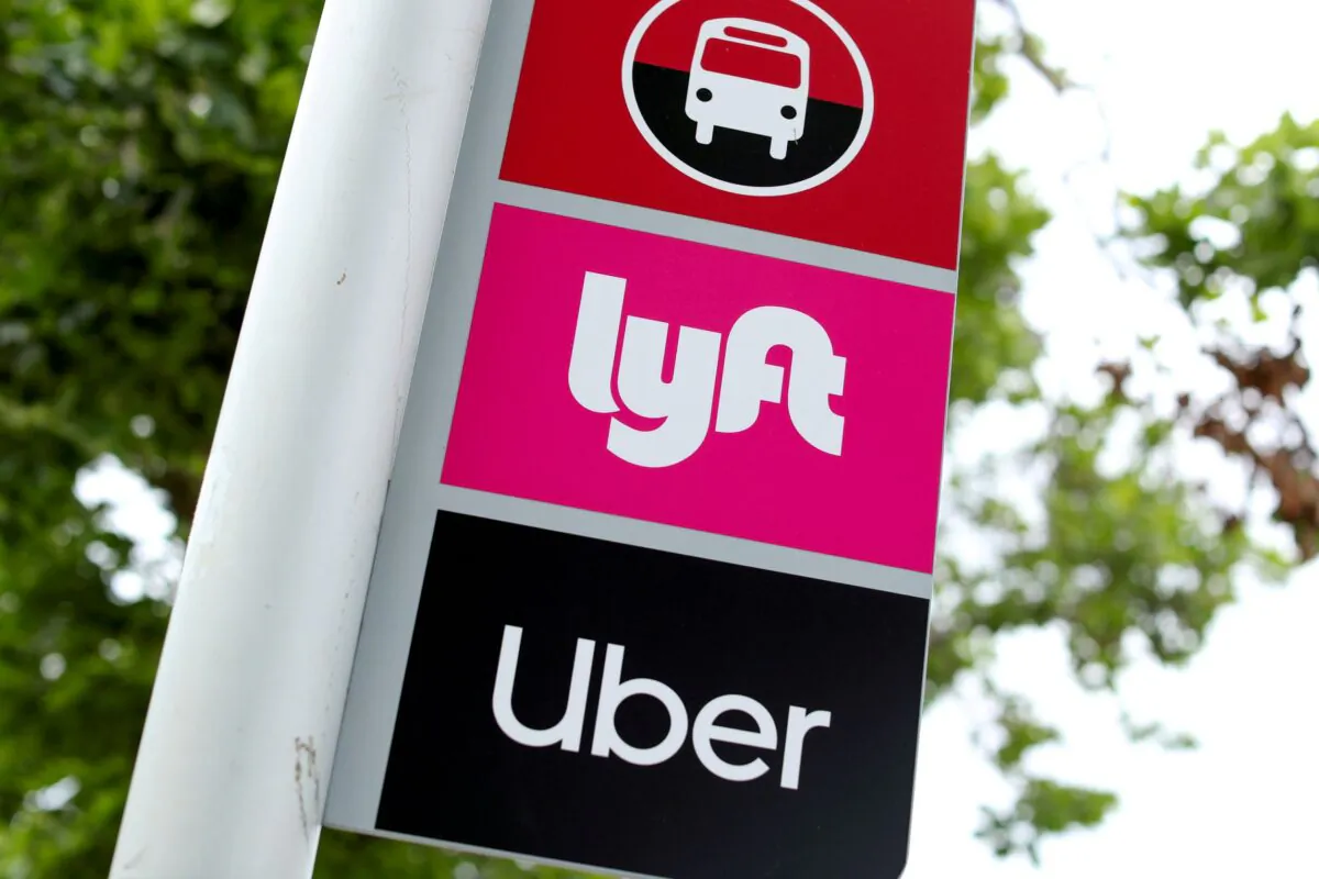 A sign marks a rendezvous location for Lyft and Uber users at San Diego State University in San Diego, Calif., on May 13, 2020. (Mike Blake/Reuters)