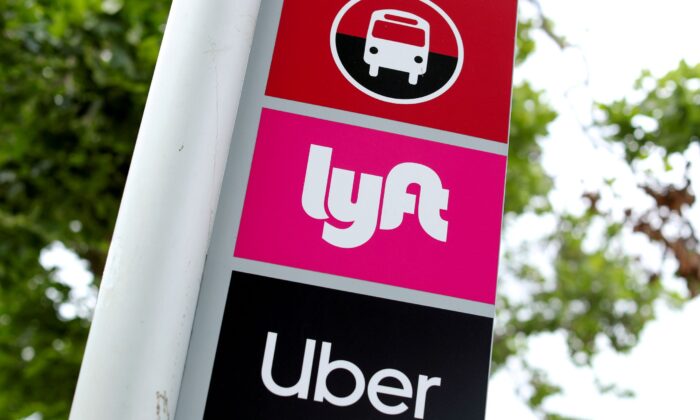 A sign marks a rendezvous location for Lyft and Uber users at San Diego State University in San Diego, Calif., on May 13, 2020. (Mike Blake/Reuters)