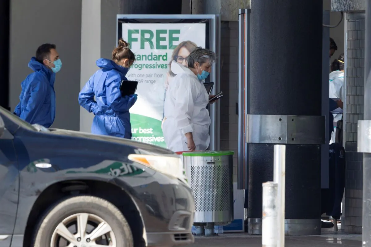 Police forensic staff stand outside a supermarket in Auckland, New Zealand on Sept. 4, 2021. (Brett Phibbs/AP Photo)