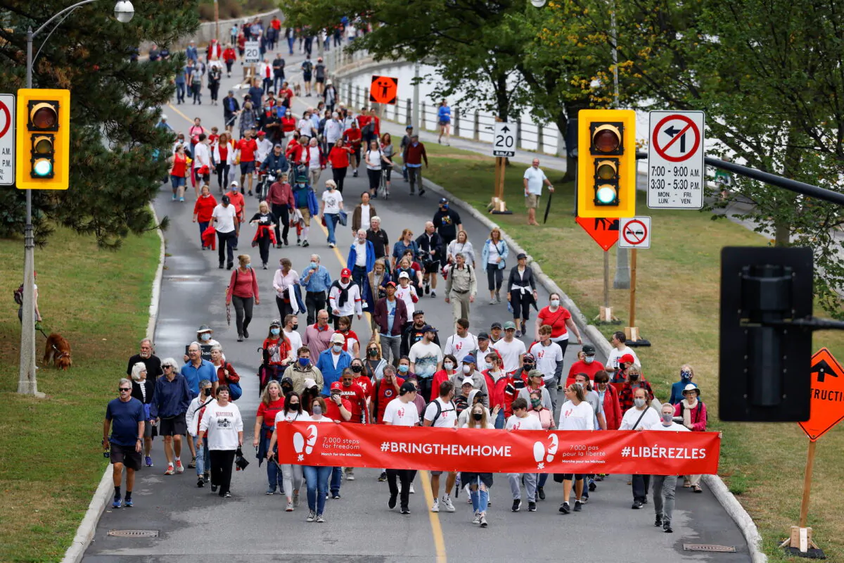 Supporters of Michael Kovrig and Michael Spavor march to mark 1,000 days since the Canadians were arrested in China, during a protest in Ottawa on Sept. 5, 2021. (Reuters/Blair Gable)