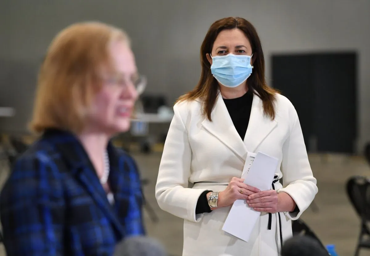Queensland Premier Annastacia Palaszczuk (right) looks on as Queensland Chief Health Officer Dr Jeannette Young (left) speaks during a press conference at the mass COVID-19 vaccination centre at the Brisbane Convention and Exhibition Centre in Brisbane, Australia, on Aug. 9, 2021. (AAP Image/Darren England)