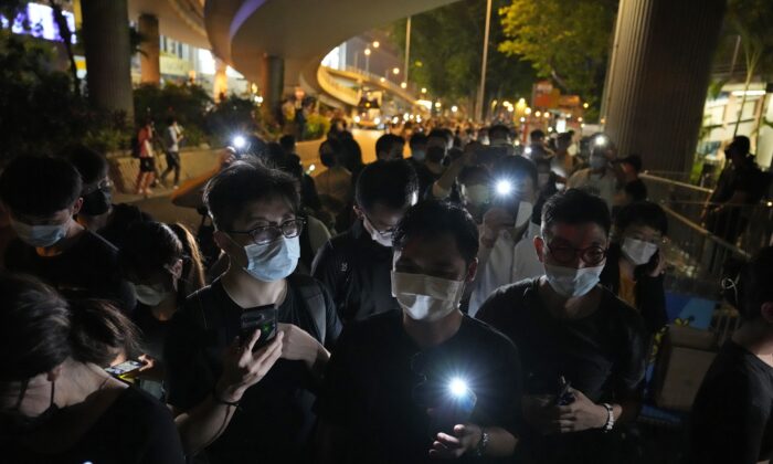 People hold LED candles to mark the anniversary of the military suppression of a pro-democracy student movement in Beijing, outside Victoria Park in Hong Kong, on June 4, 2021. (Kin Cheung/AP Photo) 