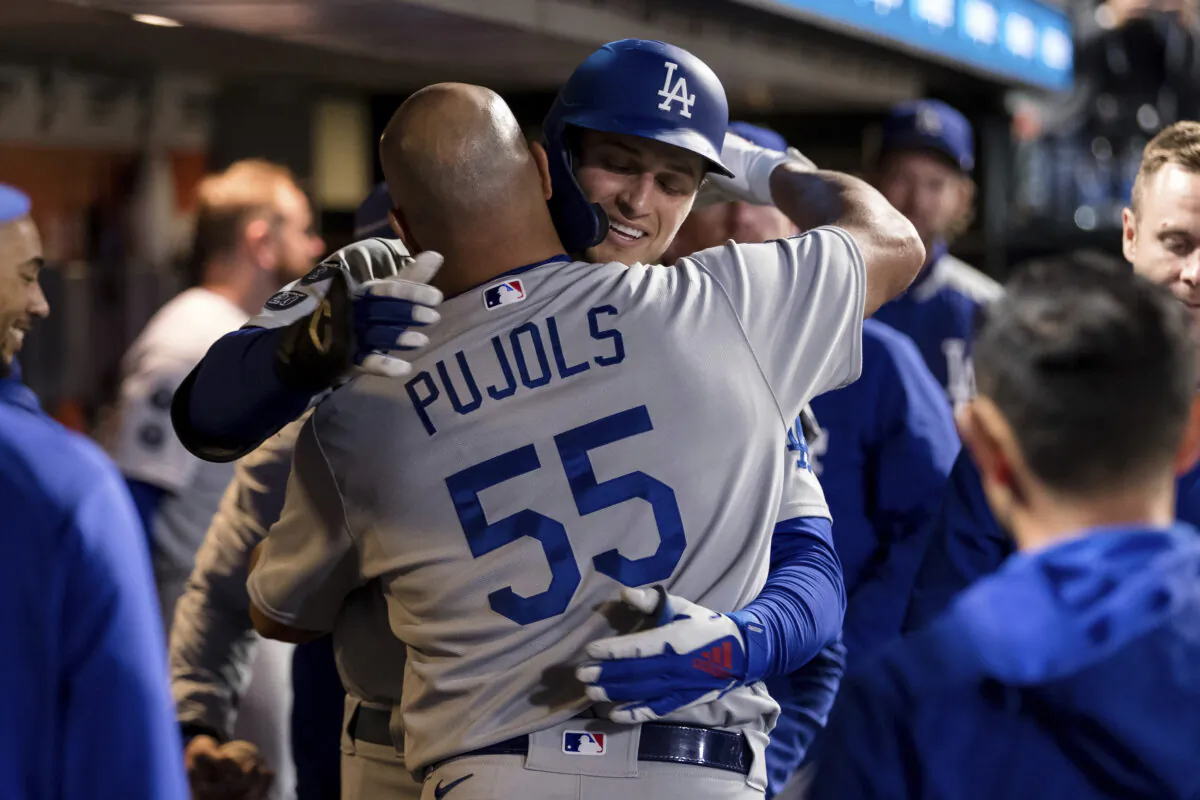 Los Angeles Dodgers' Corey Seager, back, celebrates with Albert Pujols (55) after hitting a solo home run against the San Francisco Giants in the ninth inning of a baseball game in San Francisco, on Sept. 4, 2021. (John Hefti/AP Photo)