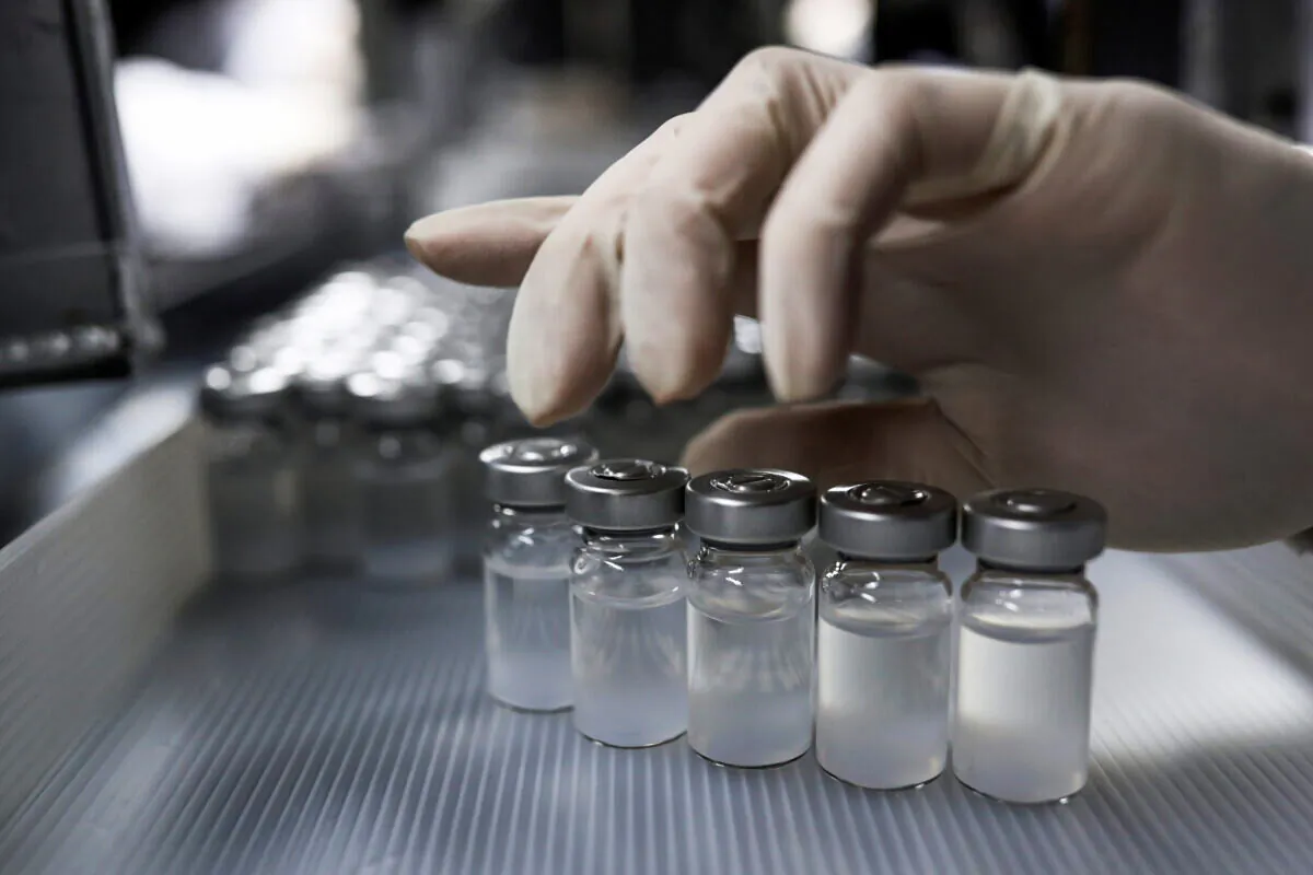 An employee handles vials containing CoronaVac, Sinovac Biotech's vaccine against the coronavirus disease (COVID-19), at Butantan biomedical center in Sao Paulo, Brazil, on Jan. 12, 2021. (Amanda Perobelli/Reuters)