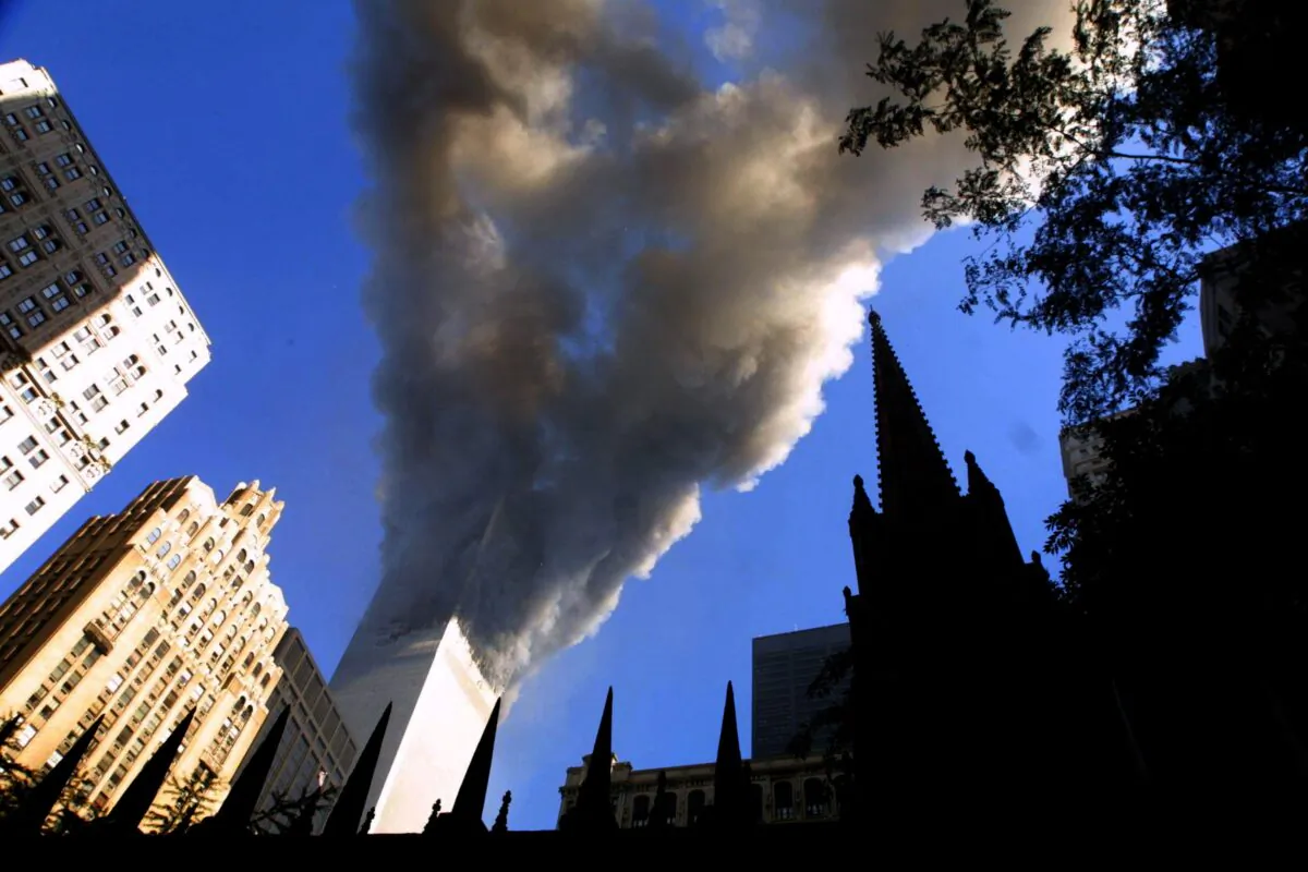 Smoke spews from a tower of the World Trade Center, after two hijacked airplanes hit the twin towers in a terrorist attack on New York City, on Sept. 11, 2001. (Mario Tama/Getty Images)