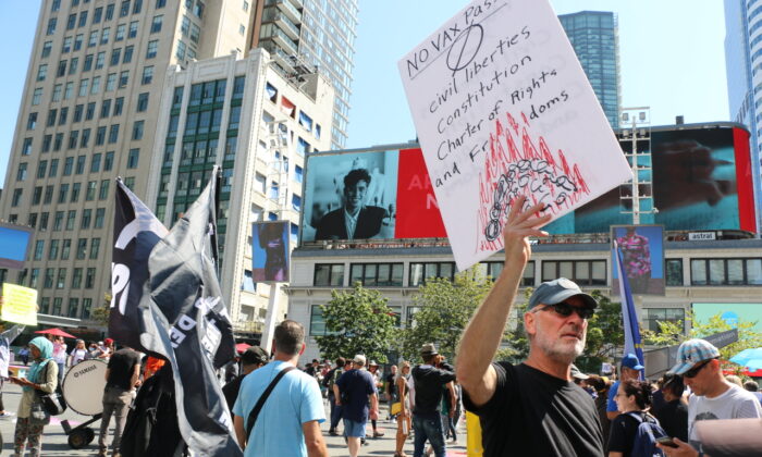 People march in downtown Toronto in protest of Ontario's mandatory COVID-19 vaccine mandate, on Sept. 4, 2021. (Andrew Chen/The Epoch Times)