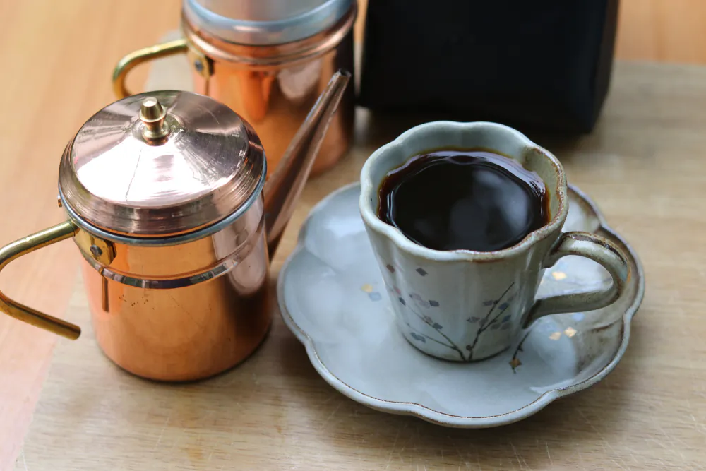 Experts recommend ground coffee with a spoonful of sugar as part of a healthy daily routine. (Charlie Waradee/Shutterstock)