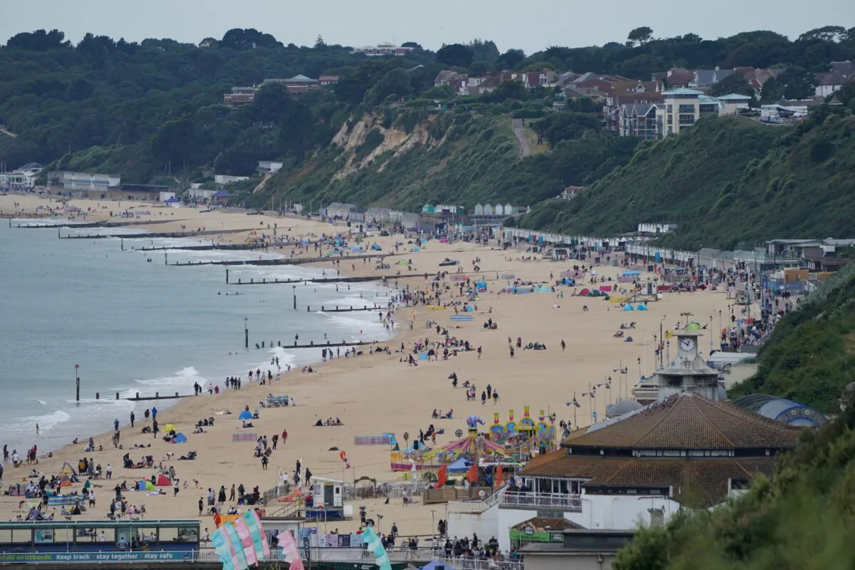 People enjoying the Bank Holiday weather on Bournemouth beach in England on Aug. 30, 2021. (Jonathan Brady/PA)