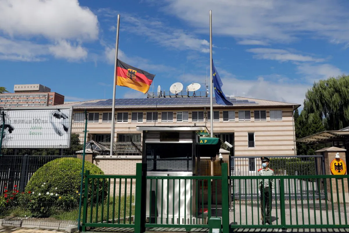The German and European Union flags fly at half mast after German ambassador to China Jan Hecker passed away, at the Germany embassy in Beijing, China, on Sept. 6, 2021. (Carlos Garcia Rawlins/Reuters)