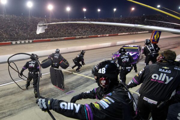 Crew members work the pit