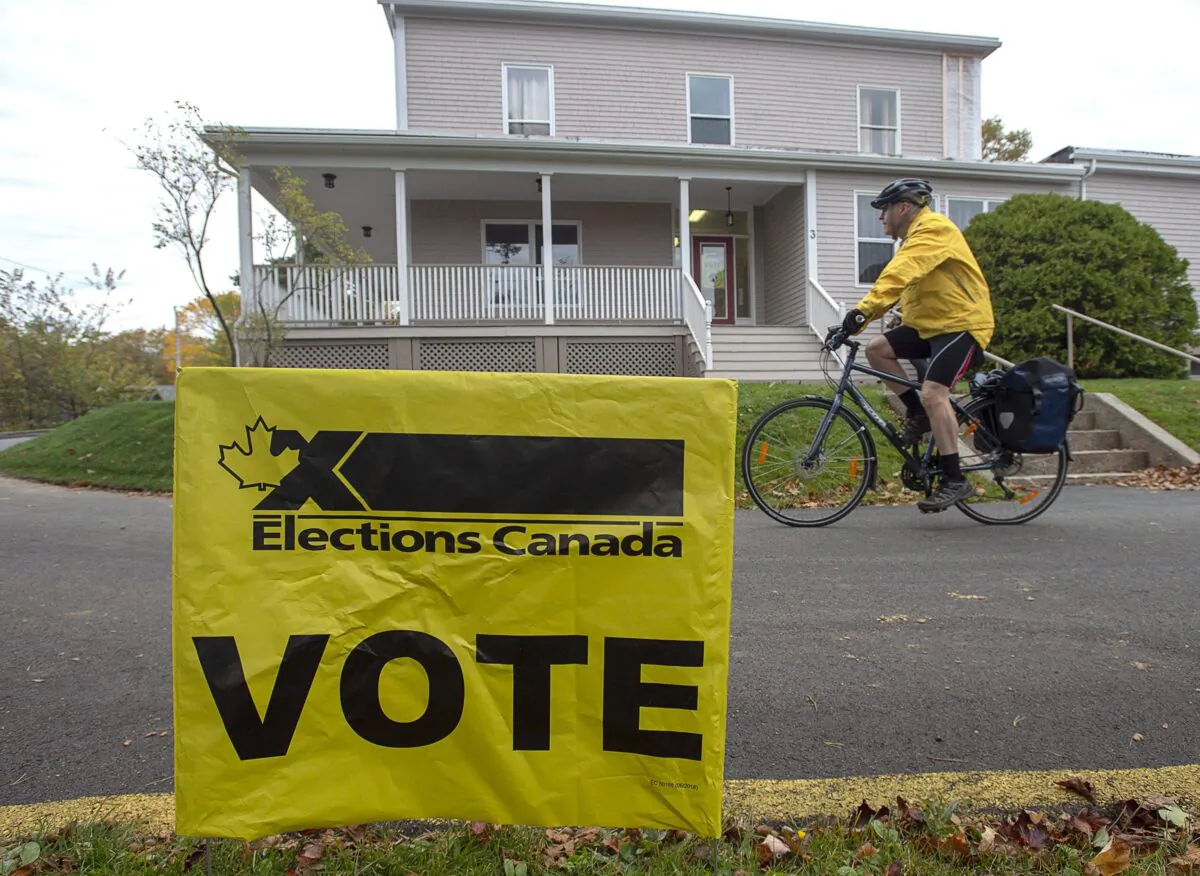 A voter rides away after casting his ballot in the 2019 federal election, in Dartmouth, N.S., on Oct. 21, 2019. (The Canadian Press/Andrew Vaughan)