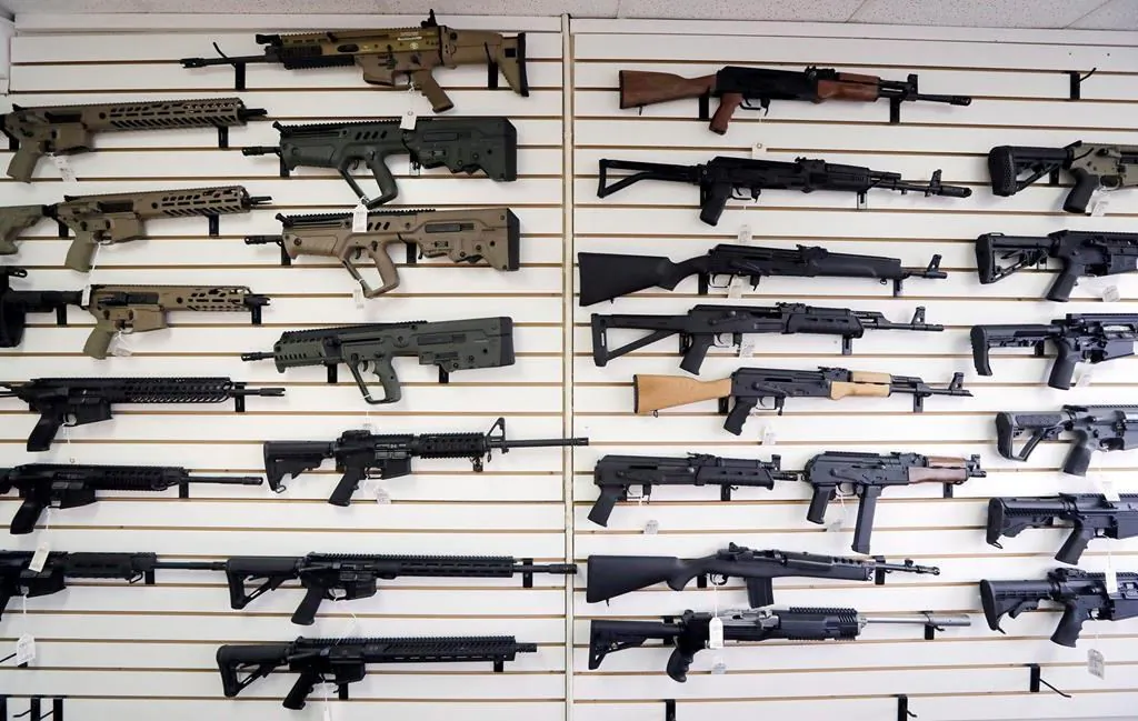 Semi-automatic rifles fill a wall at a gun shop in Lynnwood, Wash. (The Canadian Press/AP-Elaine Thompson)