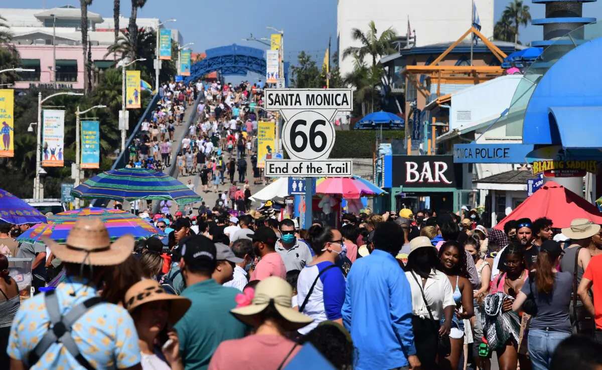 A crowd make their way to the end of the trail of Route 66 at Santa Monica Pier, in Santa Monica, Calif., on Sept. 5, 2021. (Frederic J. Brown/AFP via Getty Images)