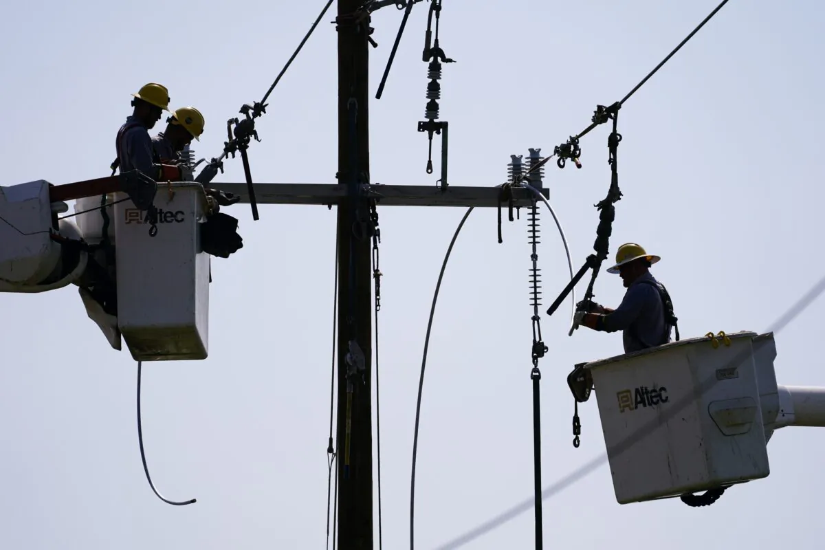 Crews work on power lines that were damaged in the aftermath of Hurricane Ida, in LaPlace, La., on Sept. 3, 2021. (Matt Slocum/AP Photo)