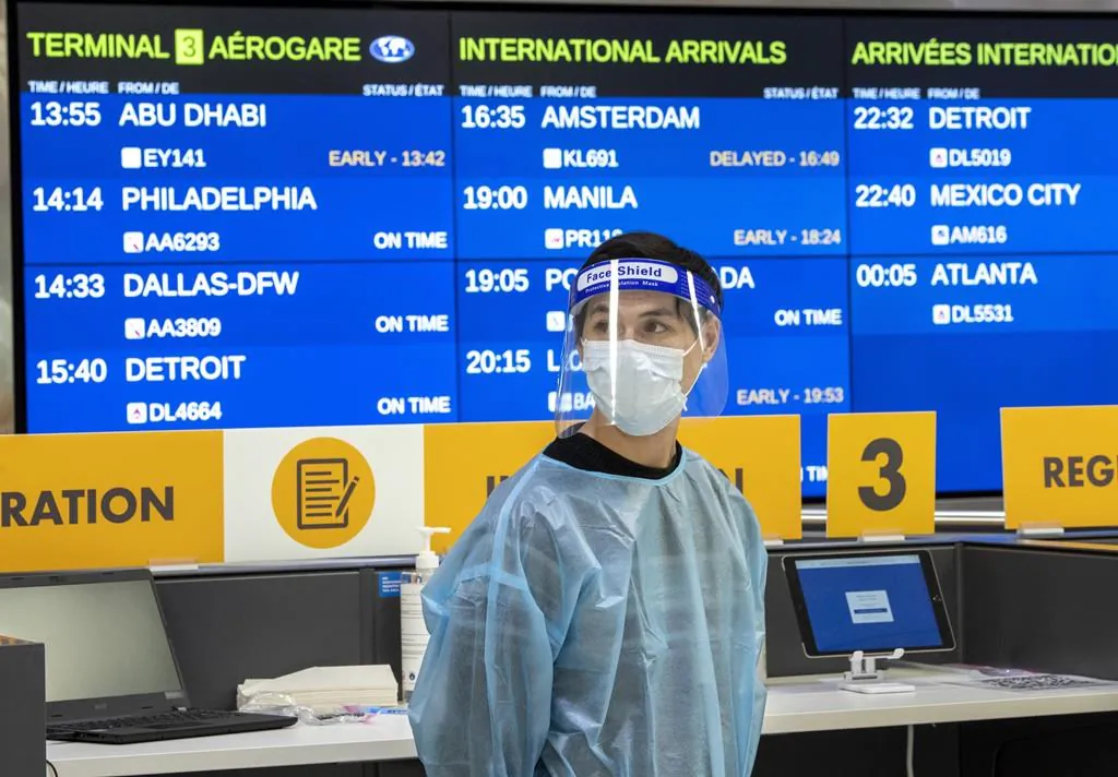 A worker waits for arrivals at the COVID-19 testing centre in Terminal 3 at Pearson Airport in Toronto, on Feb. 3, 2021. The federal government has added fully vaccinated foreign nationals to the ranks of travellers who are once again welcome on Canadian soil. (The Canadian Press/Frank Gunn)
