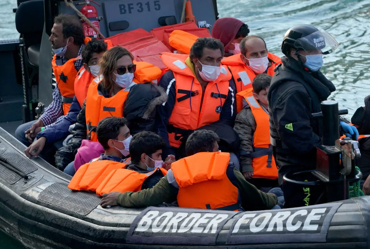 A group of people who crossed the channel from France are brought in to Dover, England, on Sept. 7, 2021. (Gareth Fuller/PA)