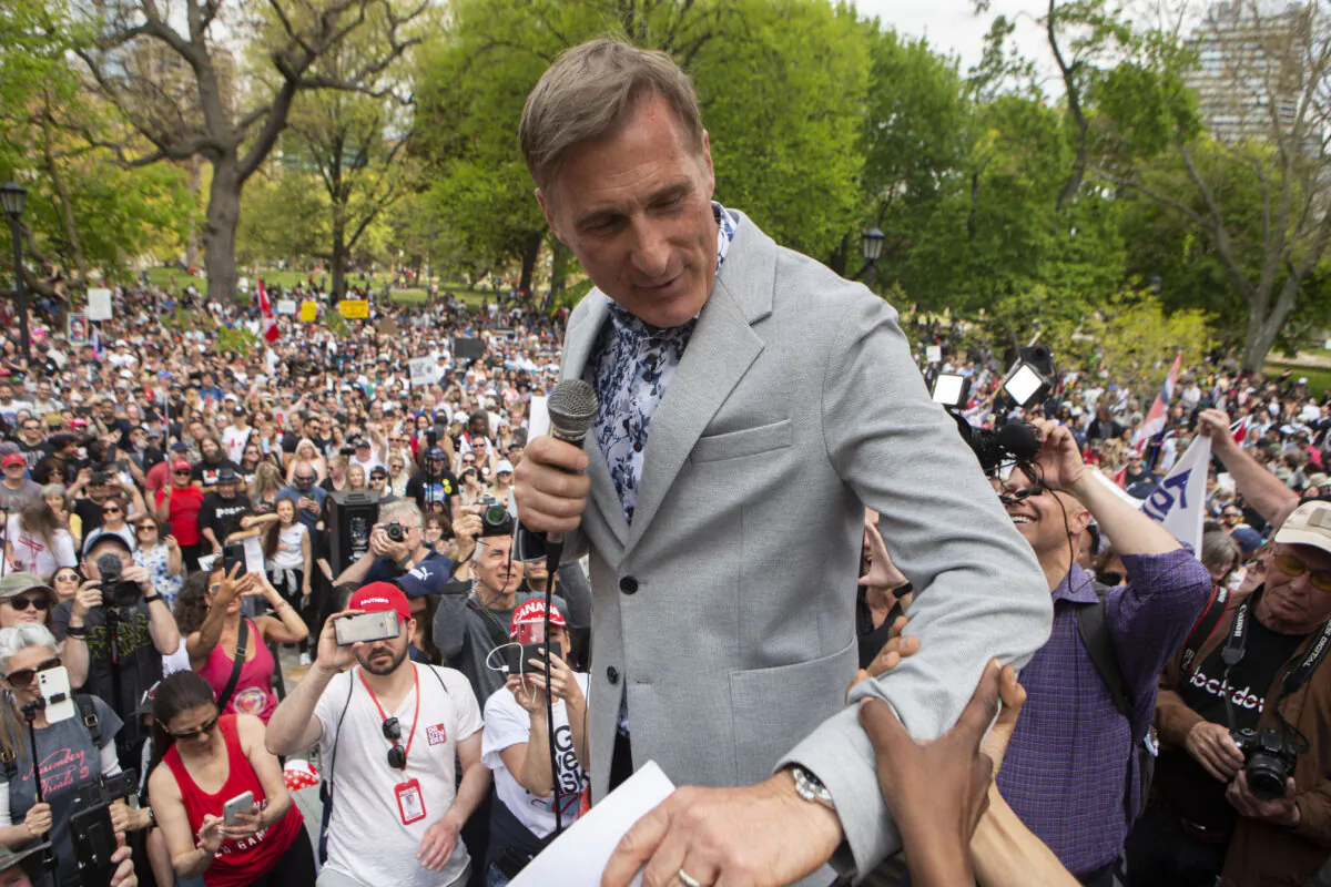 Maxime Bernier, Leader of the People's Party of Canada, prepares to speak to the crowd as protesters demonstrate against measures taken by government and public health authorities to curb the spread of COVID-19, in Toronto on May 15, 2021. (The Canadian Press/Chris Young)