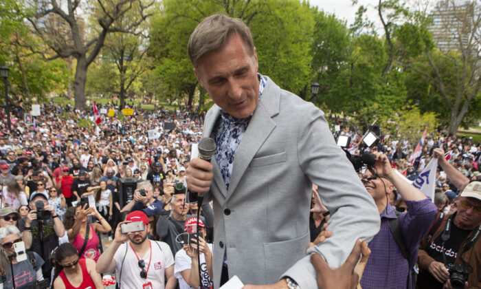 Maxime Bernier, Leader of the People's Party of Canada prepares to speak to the crowd as protesters demonstrate against measures taken by government and public health authorities to curb the spread of COVID-19, in Toronto on May 15, 2021. (The Canadian Press/Chris Young)